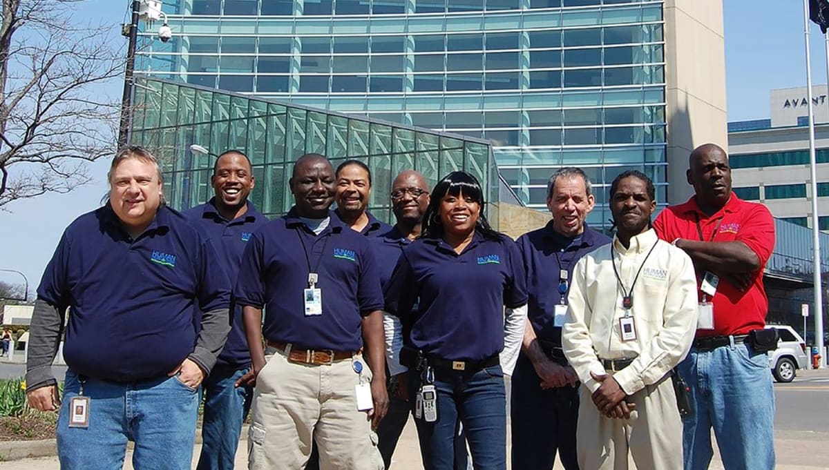 Human Technologies employees standing together in front of the Utica headquarters.